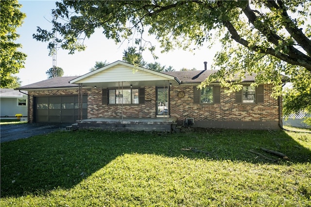 single story home with a front yard and a garage