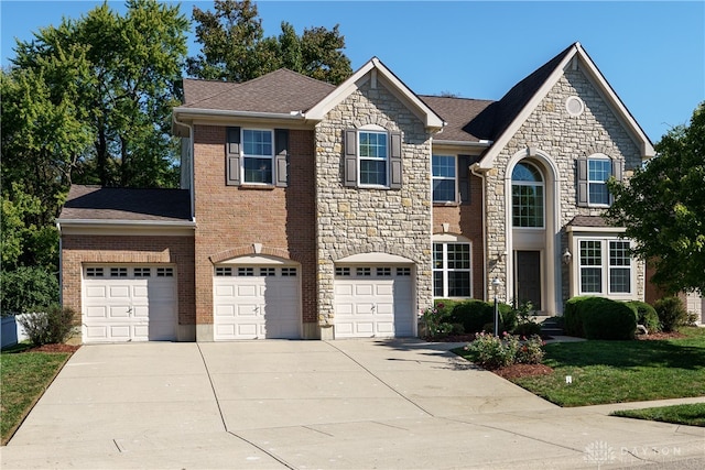 view of front of house with a front lawn and a garage