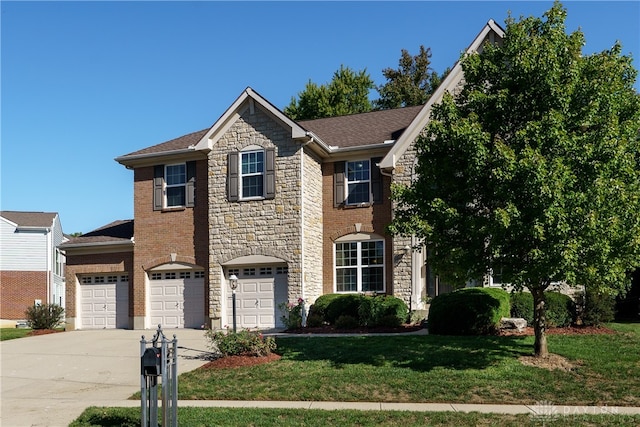 view of front of house featuring a front lawn and a garage