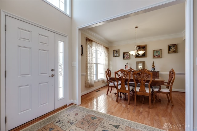 foyer featuring light hardwood / wood-style floors and ornamental molding