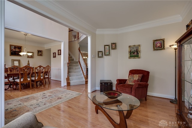 interior space featuring a notable chandelier, crown molding, and light hardwood / wood-style flooring