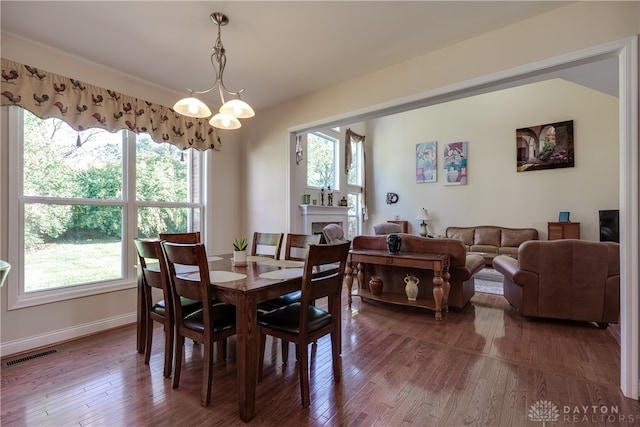 dining area featuring a notable chandelier and hardwood / wood-style floors