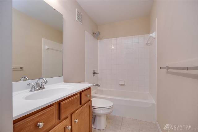 full bathroom with tiled shower / bath, tile patterned floors, vanity, and toilet