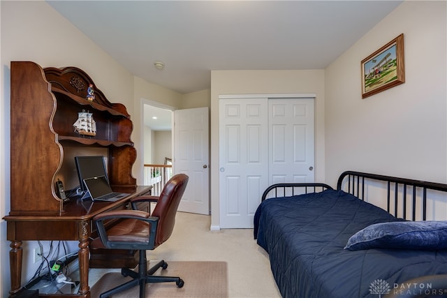 bedroom with a closet and light carpet