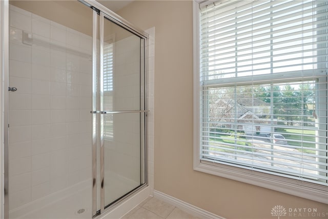 bathroom featuring walk in shower and tile patterned flooring