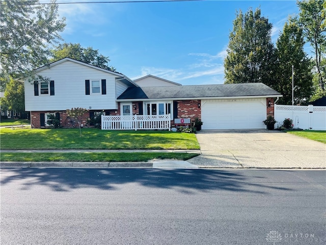 split level home with a front lawn and a garage