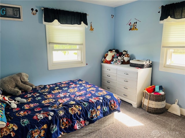 carpeted bedroom featuring multiple windows