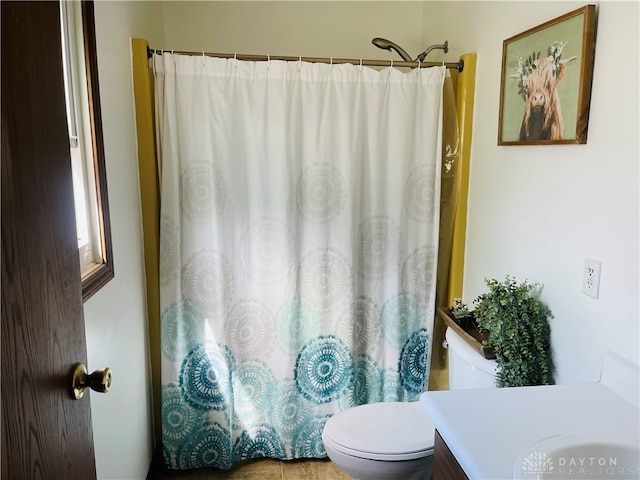 bathroom with walk in shower, tile patterned flooring, vanity, and toilet