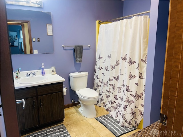 bathroom with a shower with shower curtain, tile patterned flooring, vanity, and toilet