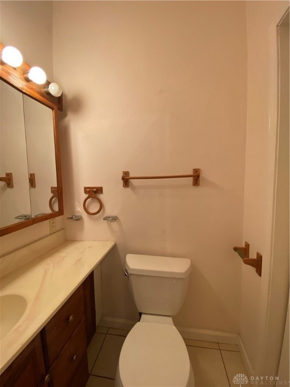 bathroom with tile patterned flooring, vanity, and toilet