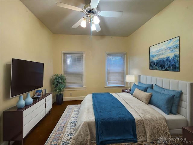 bedroom with ceiling fan and dark hardwood / wood-style floors