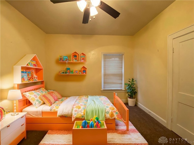 bedroom with ceiling fan and dark carpet