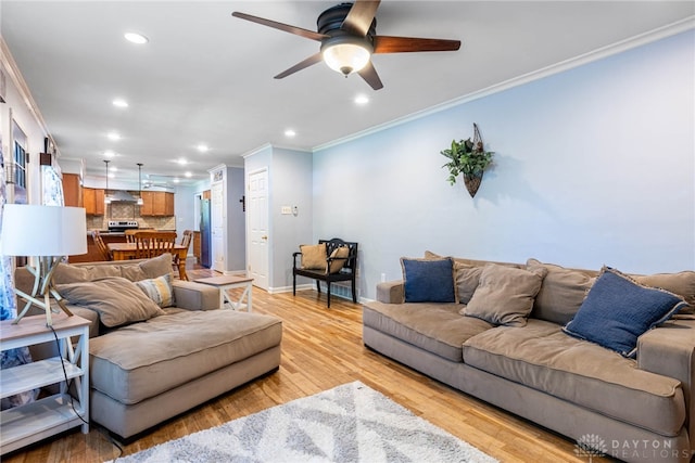 living room with light wood-type flooring, crown molding, and ceiling fan