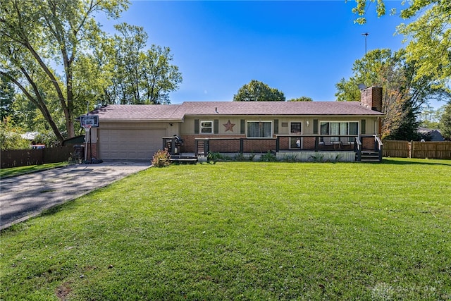 single story home featuring a front lawn and a garage