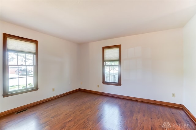 unfurnished room featuring dark hardwood / wood-style flooring