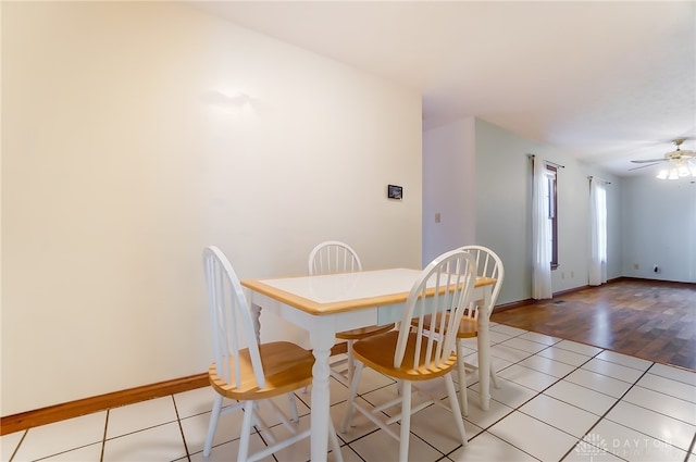 dining space with ceiling fan and light hardwood / wood-style floors