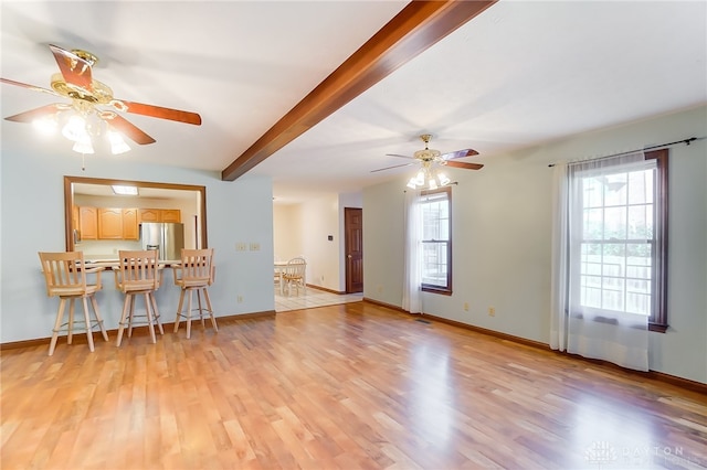 living room featuring beam ceiling, ceiling fan, and light hardwood / wood-style flooring