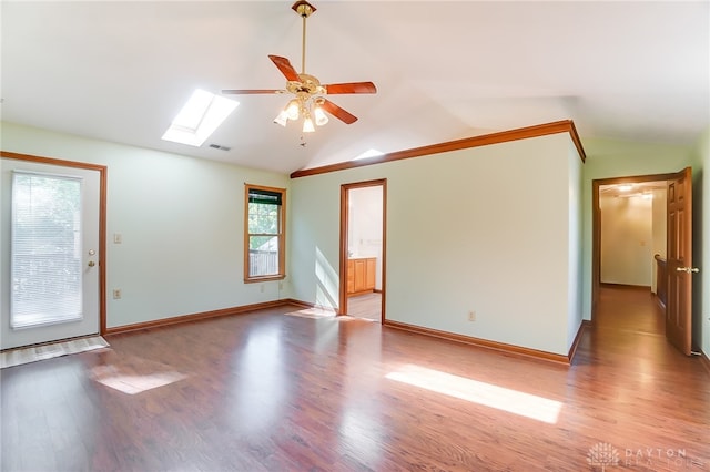 empty room with vaulted ceiling with skylight, light hardwood / wood-style floors, and plenty of natural light