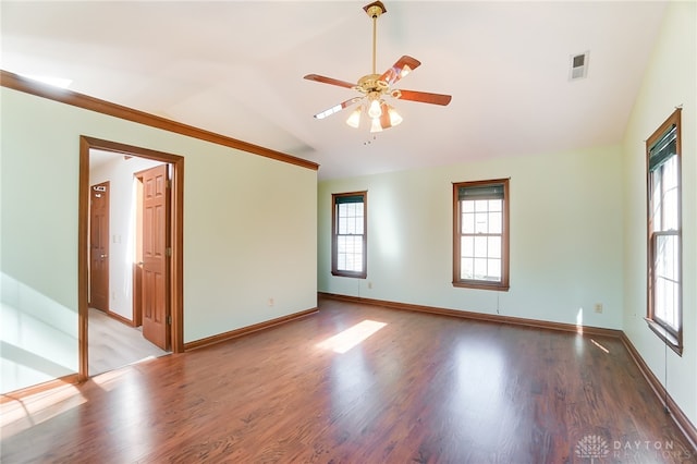 spare room featuring wood-type flooring, lofted ceiling, ceiling fan, and a wealth of natural light