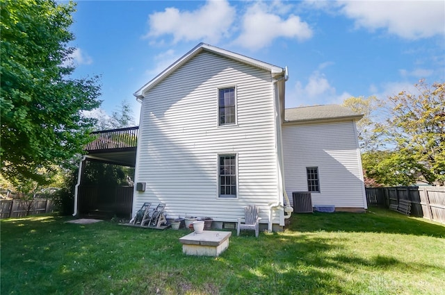 rear view of property featuring a lawn