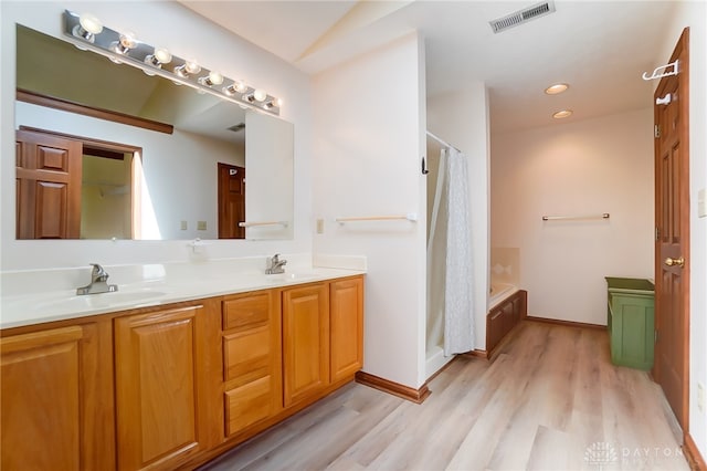 bathroom featuring vanity, hardwood / wood-style flooring, and independent shower and bath