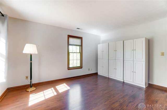 unfurnished bedroom featuring dark hardwood / wood-style floors