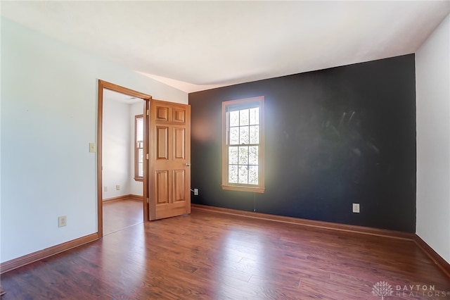 spare room with wood-type flooring