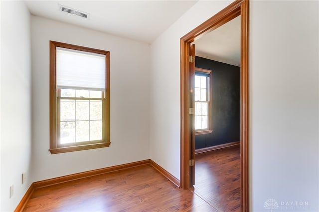 empty room with hardwood / wood-style flooring