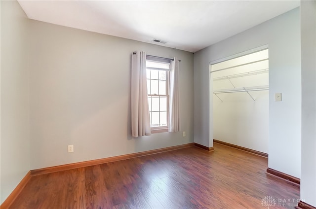 unfurnished bedroom featuring hardwood / wood-style floors and a closet