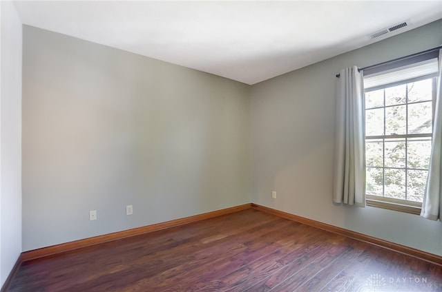 empty room featuring dark wood-type flooring