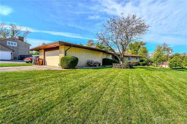 single story home featuring a front lawn and a garage