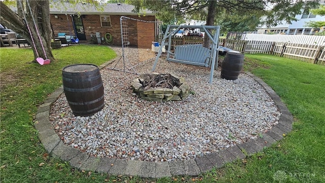 view of yard featuring a fire pit and a playground