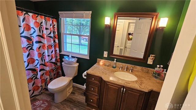 bathroom with toilet, wood-type flooring, vanity, and a shower with curtain