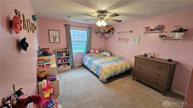 carpeted bedroom featuring a textured ceiling and ceiling fan