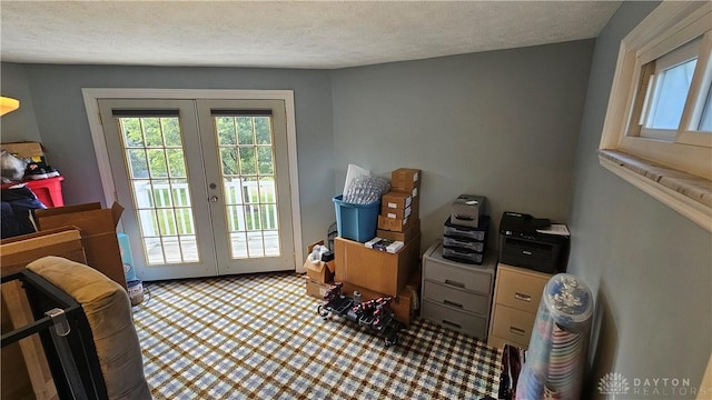 doorway with a textured ceiling and french doors