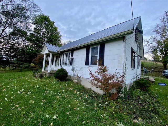 view of property exterior with a yard