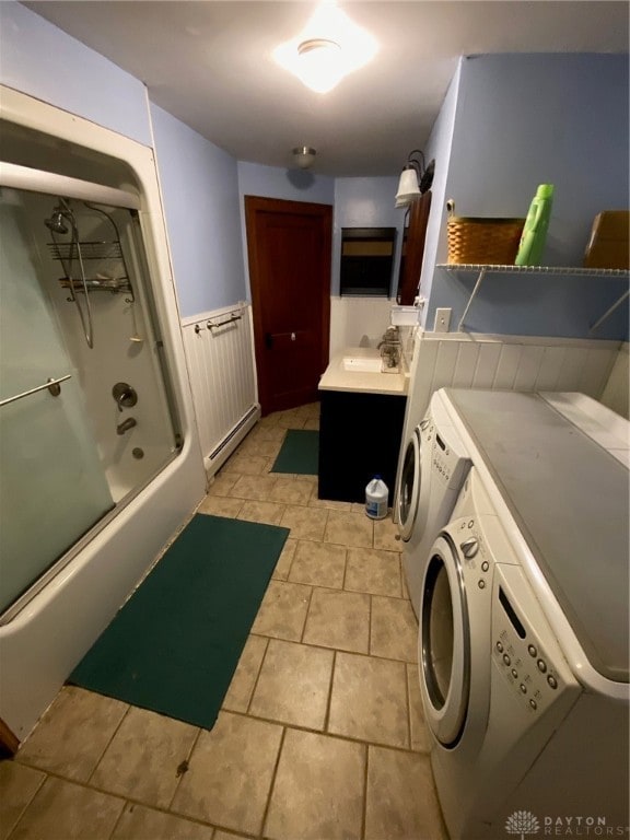 bathroom with shower / bath combination with glass door, vanity, baseboard heating, and separate washer and dryer