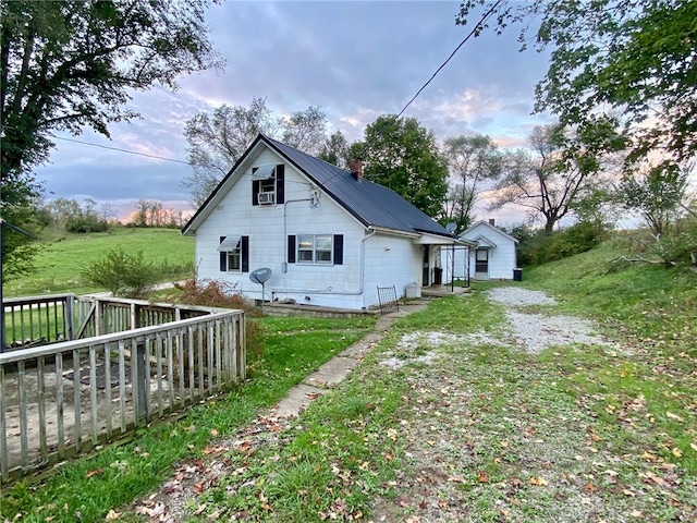 view of property exterior with a lawn and a deck