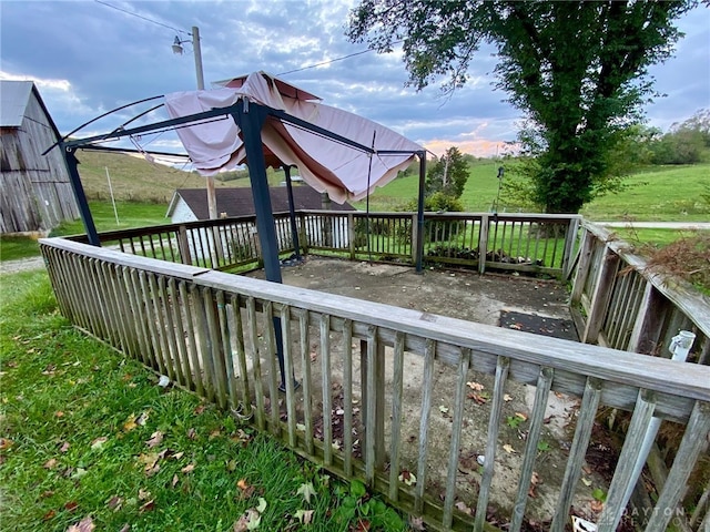 wooden terrace with a lawn