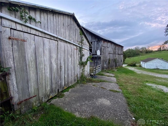 2586 State Route 763, Aberdeen, OH 45101 - view of property exterior featuring a barn, an outbuilding, and a lawn