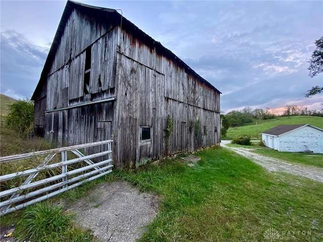 view of outbuilding with a lawn