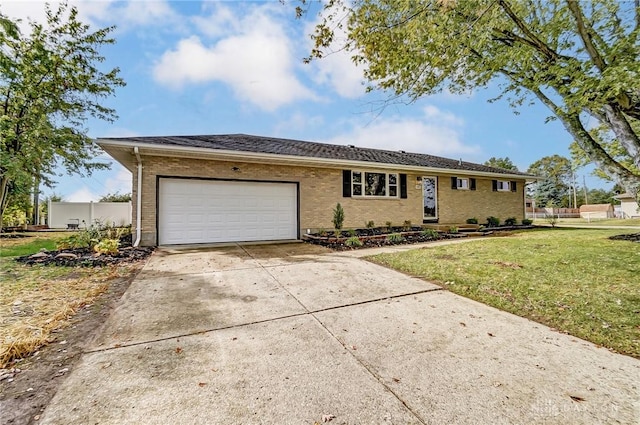 single story home featuring driveway, brick siding, a garage, and a front yard