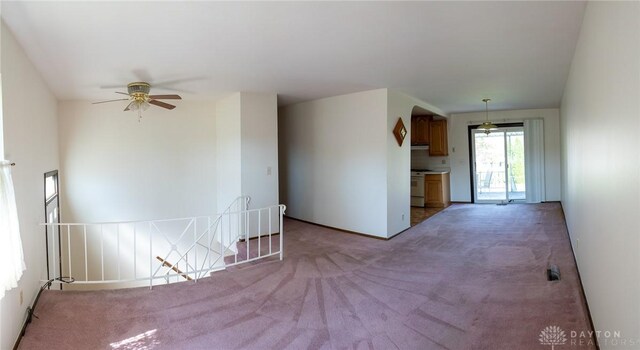 unfurnished living room with ceiling fan and carpet flooring