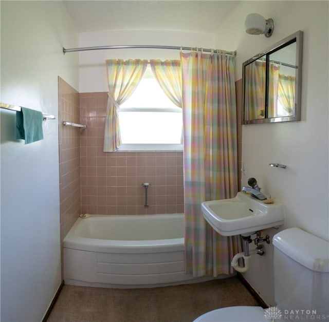 bathroom featuring shower / bath combination with curtain and toilet