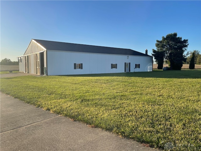 view of side of property with a yard