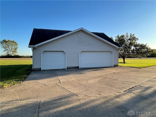 view of home's exterior with a garage and a lawn