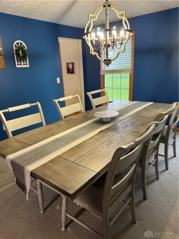 carpeted dining space with a textured ceiling and a chandelier