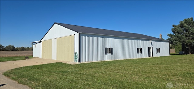 view of outdoor structure featuring a lawn