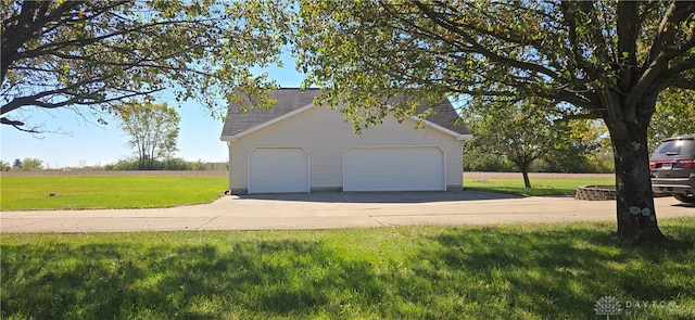 garage featuring a lawn