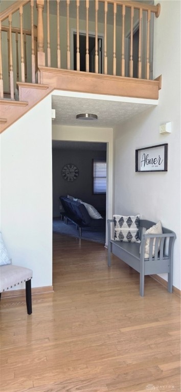 corridor featuring a textured ceiling and hardwood / wood-style flooring